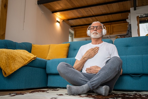mature man meditating couch