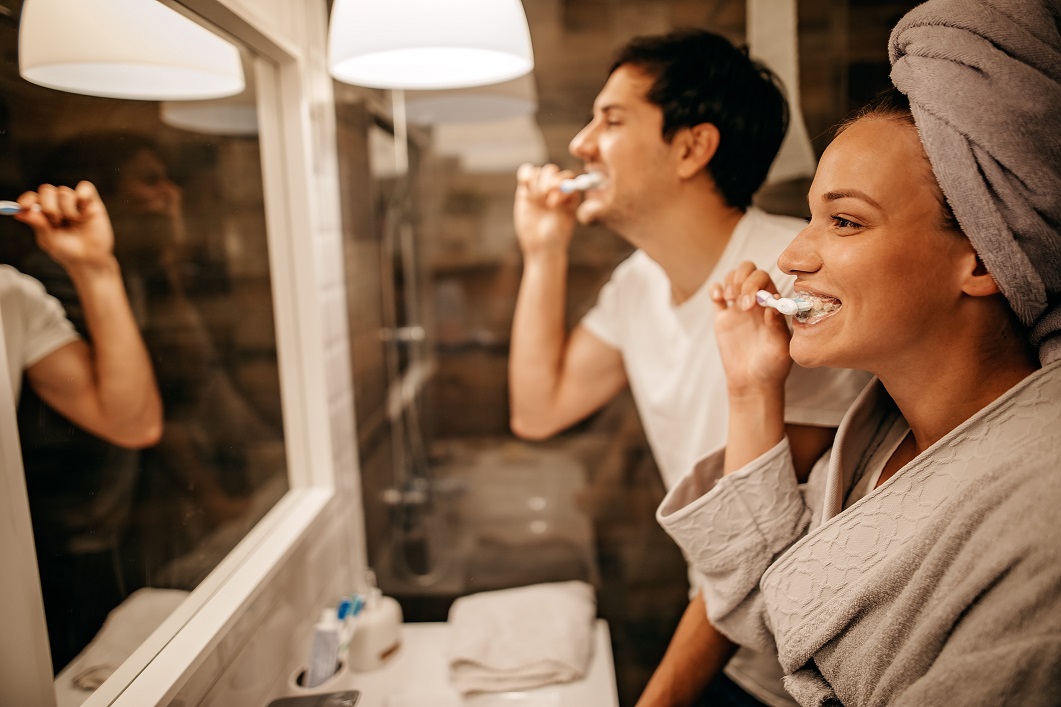 young couple brushing teeth health